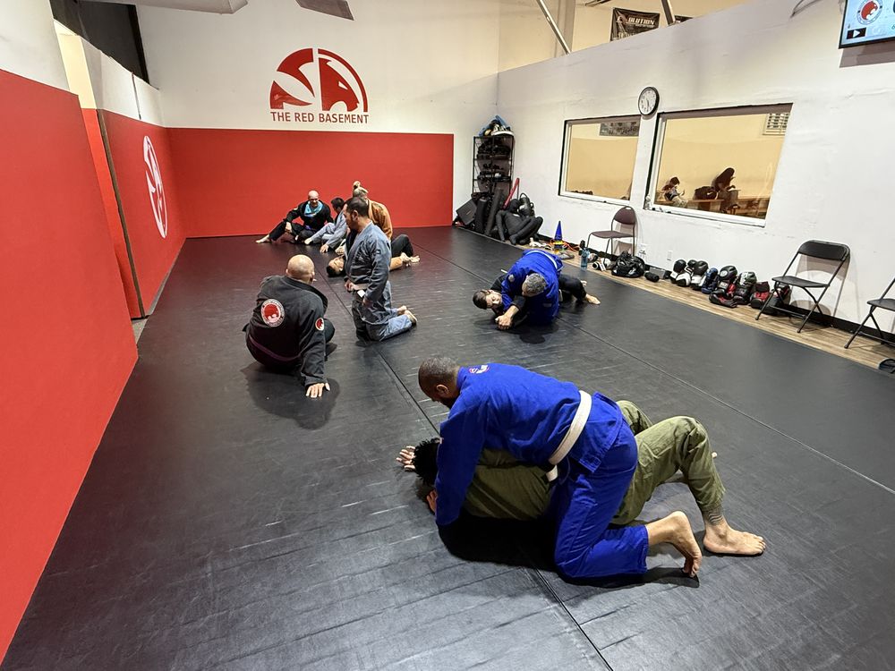 Adult Brazilian Jiu-Jitsu students rolling in the gi on the Red Basement mat at Renzo Gracie Evolution in Chatsworth