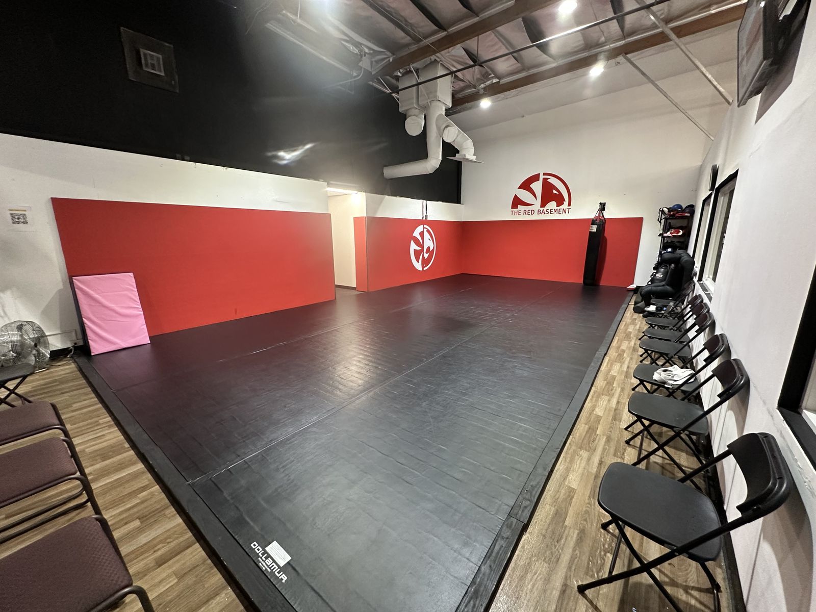 The Red Basement striking room at Renzo Gracie Evolution in Chatsworth with mats and folding chairs